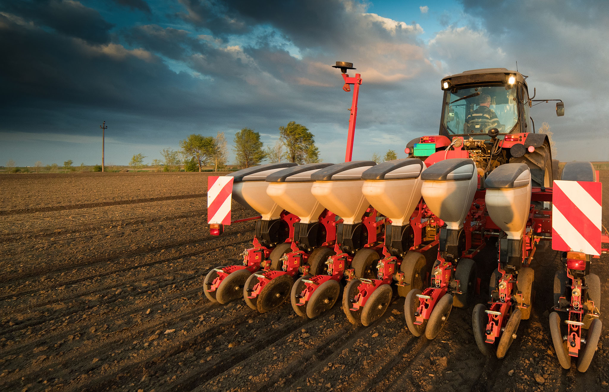 Farmer with tractor seeding